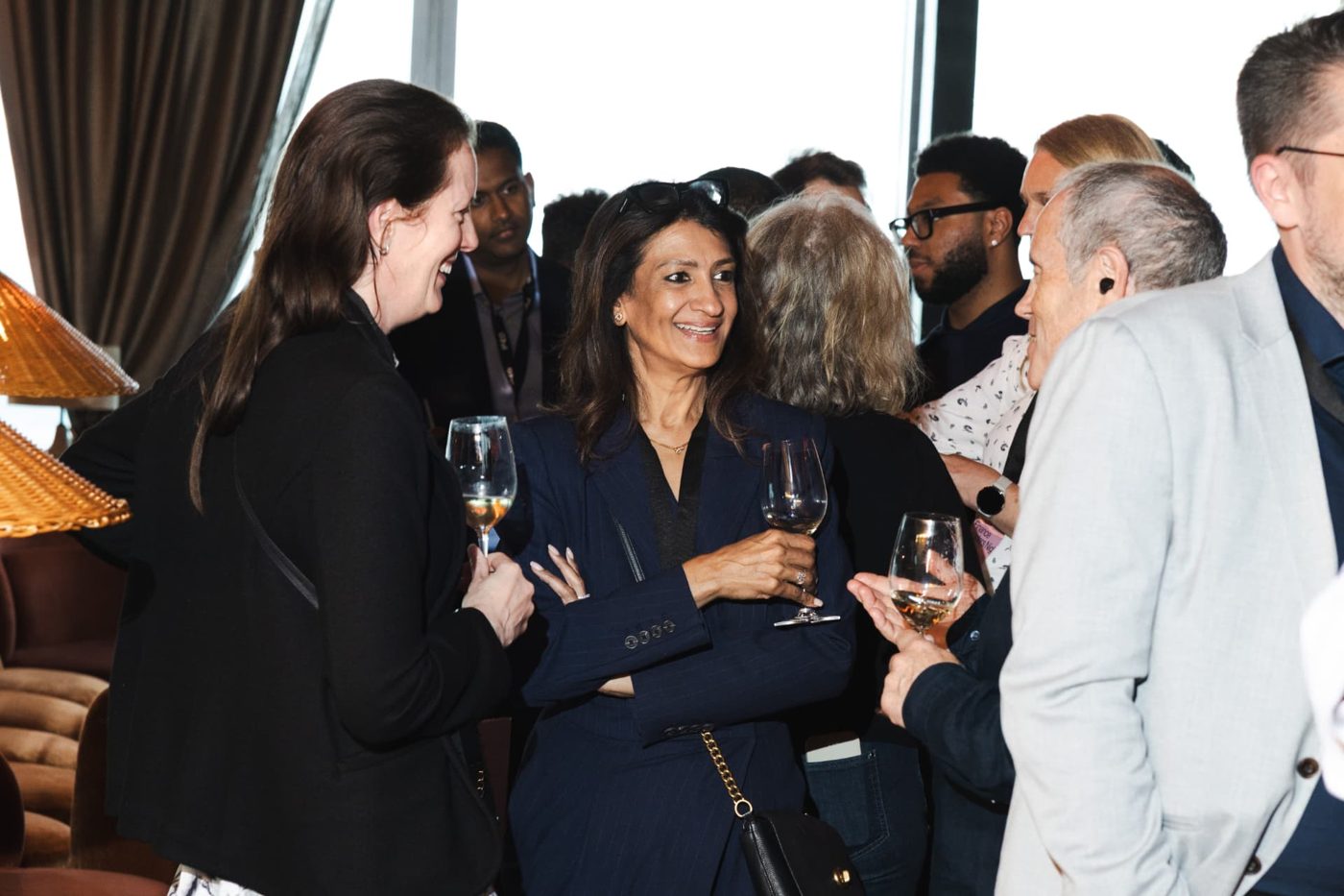 Decision-makers in conversation over drinks at an ELN event